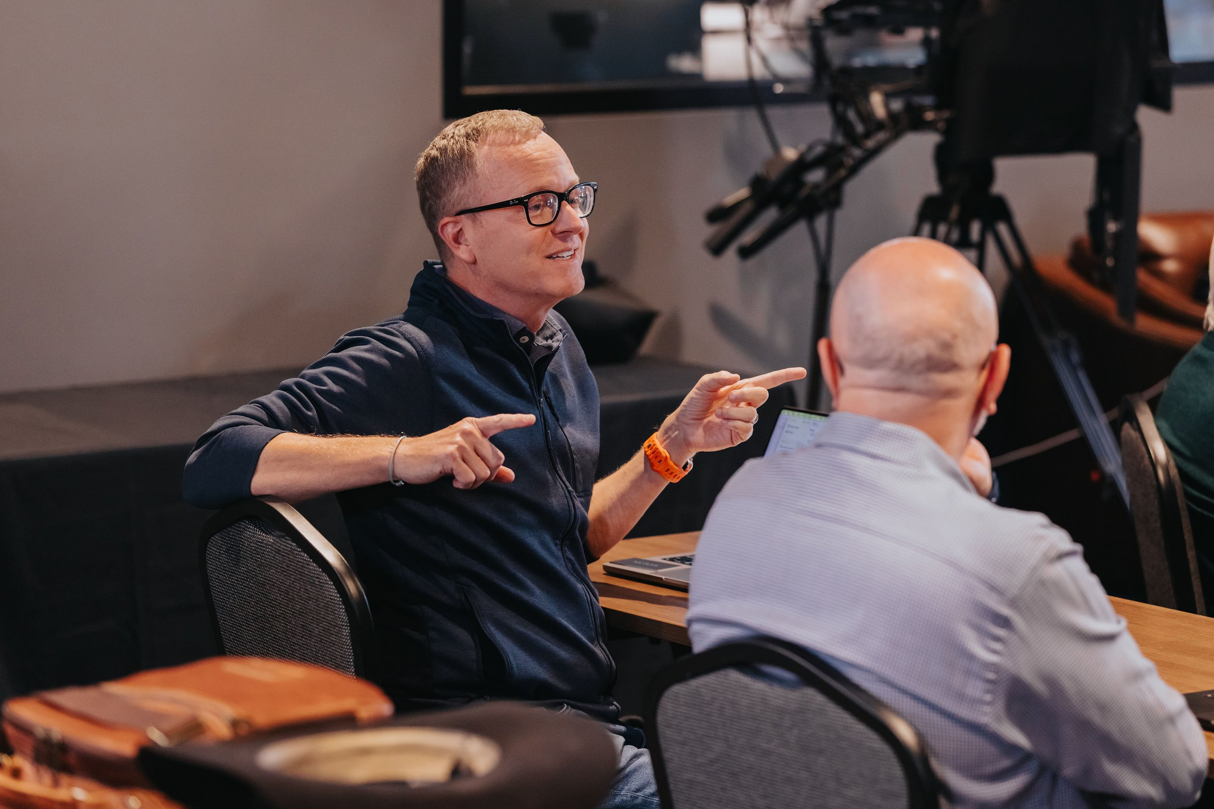 Scott M. Curran speaking in a live conversation setting